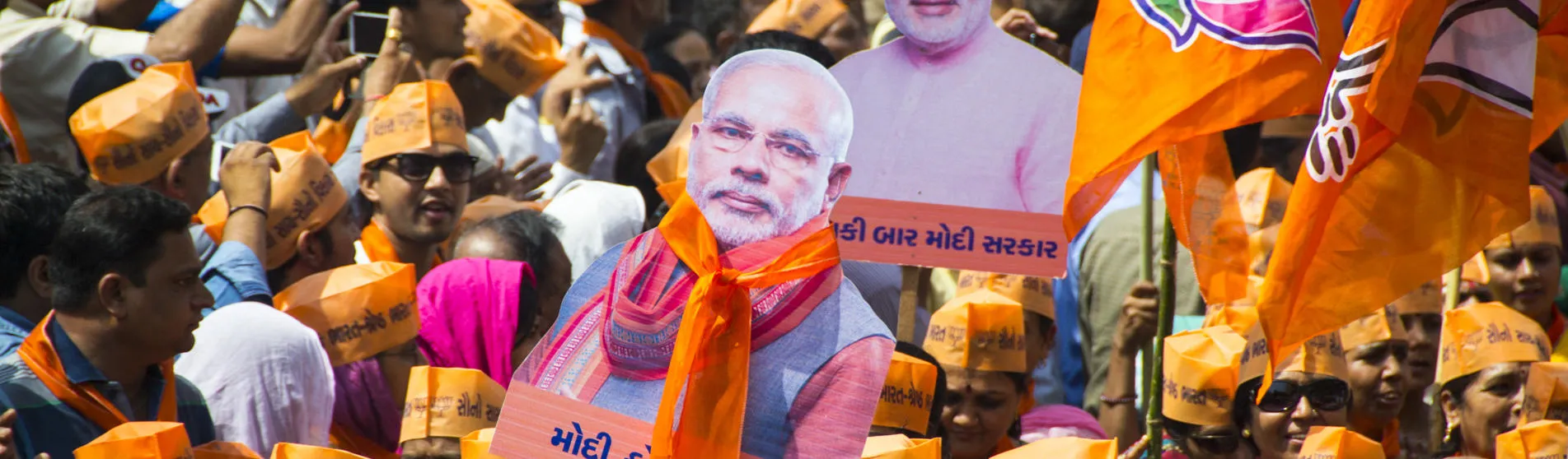 Supporters of Narendra Modi holding up banners of his image