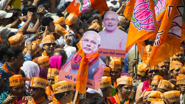 Supporters of Narendra Modi holding up banners of his image