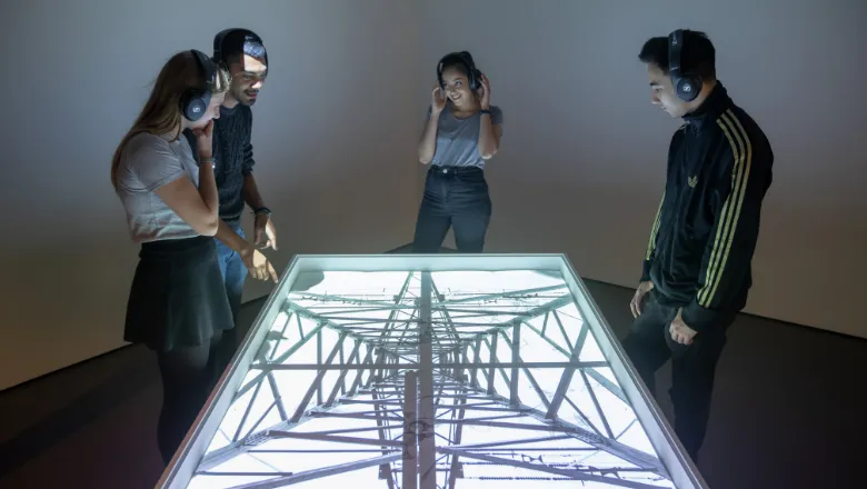 Young People looking at installation inside a gallery room