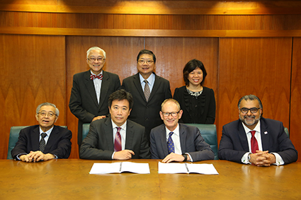 Ngee Ann and King's representatives signing the partnership