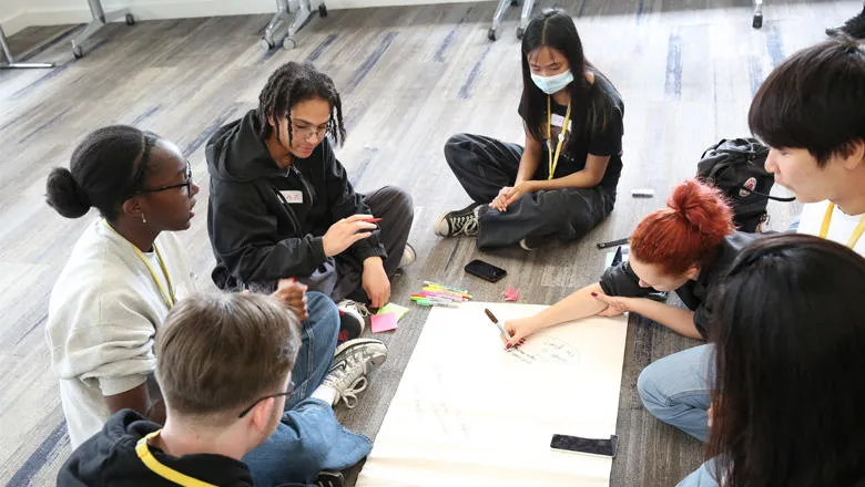 Students from King's Maths School work in groups to create disruptive solutions to societal challenges.