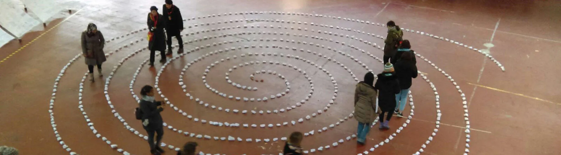 Members of the public wander through the spiral of wrapped clay hearts during the 'Moving Hearts' exhibition