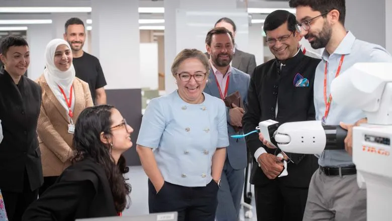 Group of people around a robot