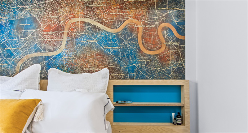 Corner of bed with a London map wall art background