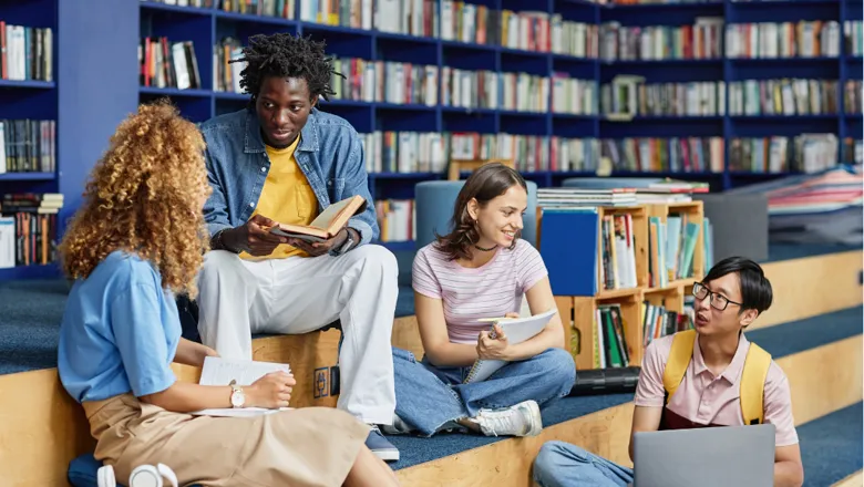 Four students working together in a library.