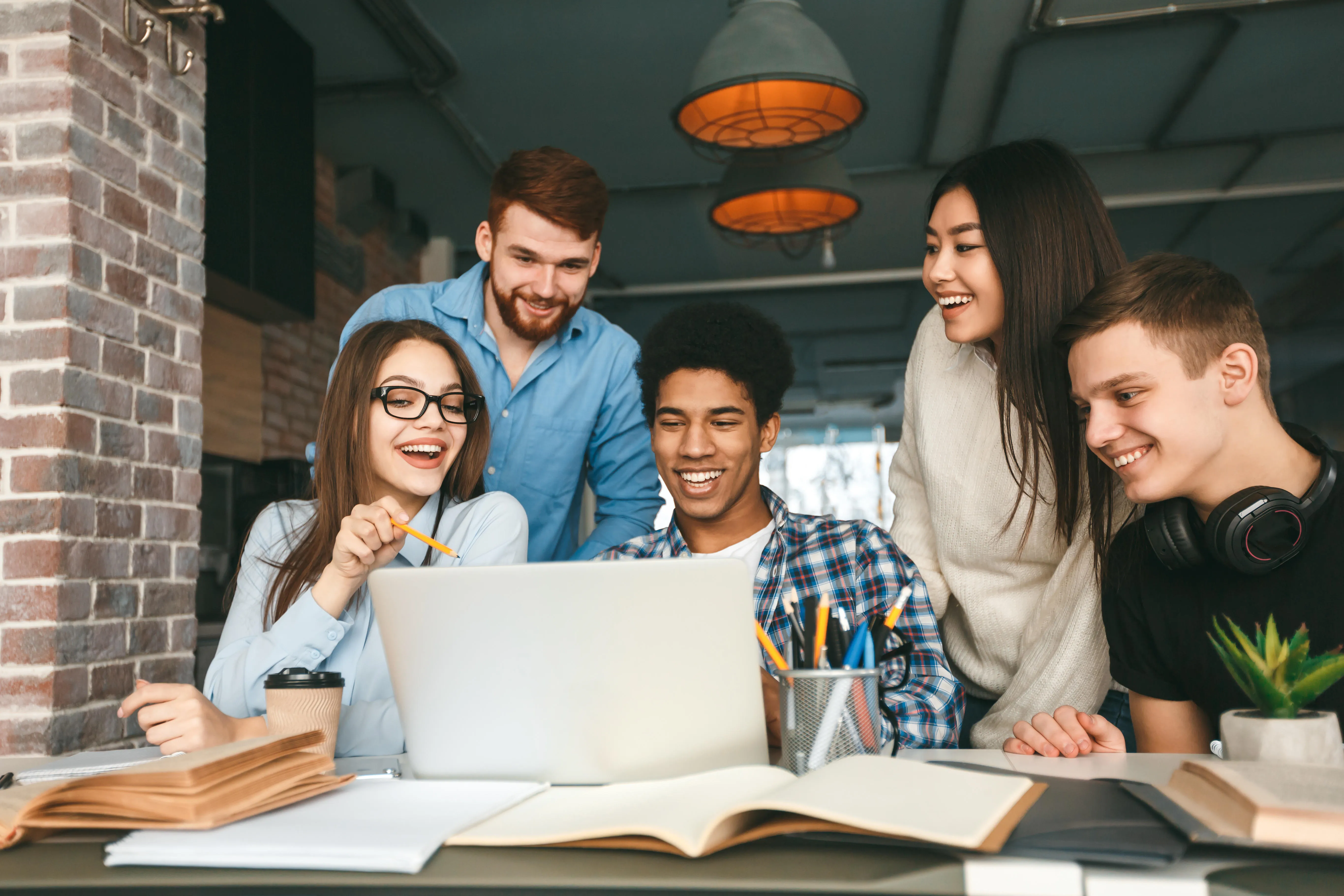 Students sitting around a laptop