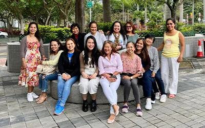 A group of women all smile at the camera