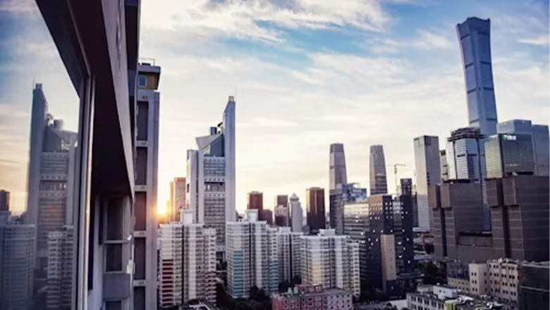 An image of Beijing's skyline, a line of steel skyscrapers against a blue sky.