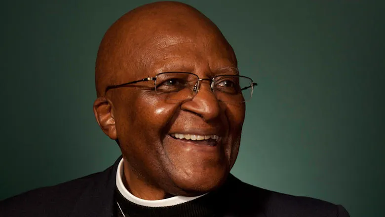 Archbishop Desmond Tutu on green background