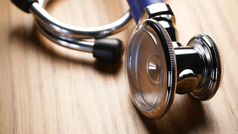 Stethoscope on wooden table top