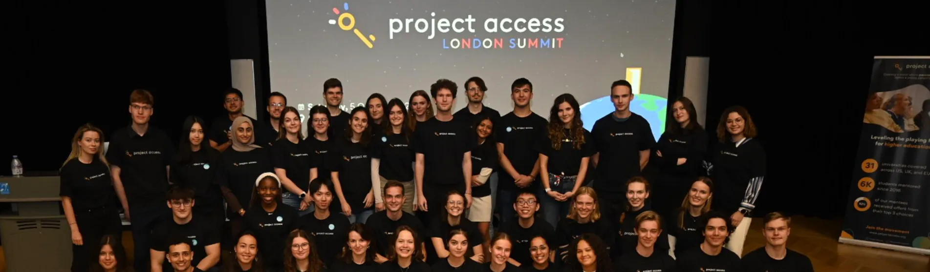 A group photo of many mentors and mentees in front of a screen that says 'project access'