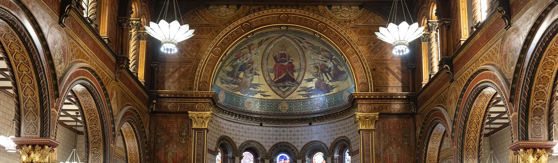 The ceiling of King's chapel, brightly lit and adorned with art