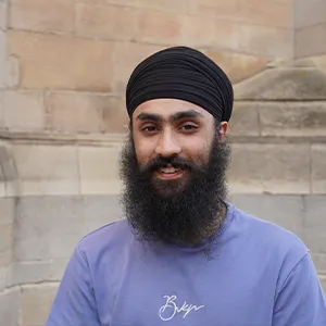 Eeshar in profile, wearing a purple jumper