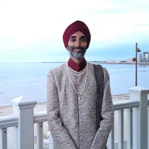 Jasvir in profile against a seaside backdrop