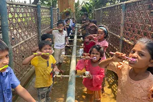 A group of schoolchildren learn how to brush their teeth properly