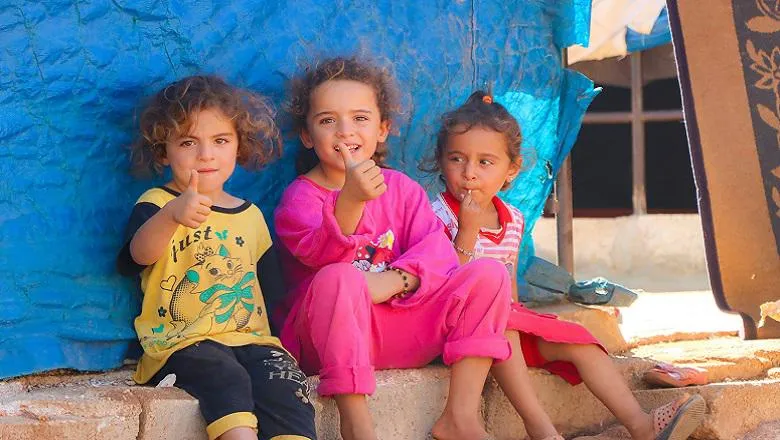 image of 3 children in refugee camp