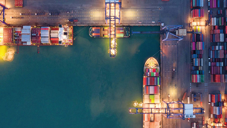 Aerial view of container ship and transportation in maritime port.