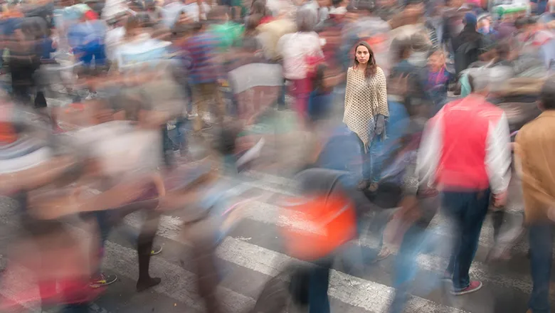 A person standing in a busy crowd
