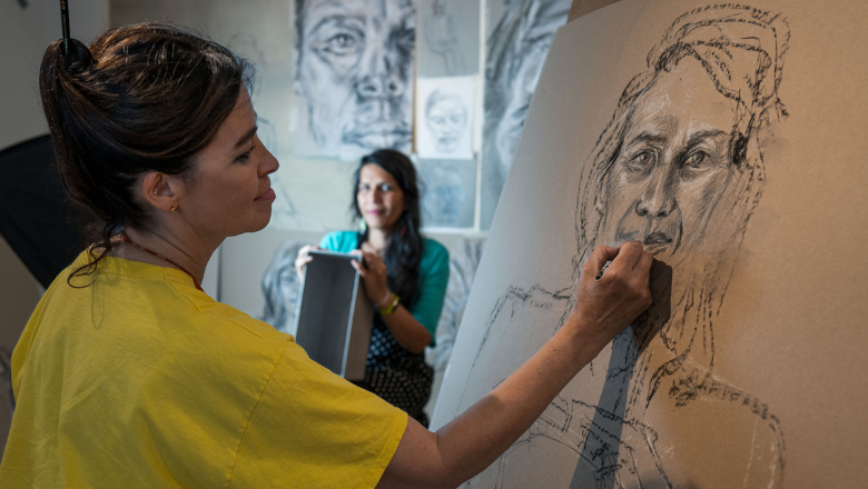 artist Es Devlin drawing a woman in a charcoal portraits