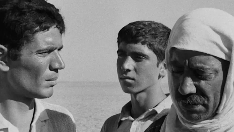 a close up of three male faces in black and white in the desert