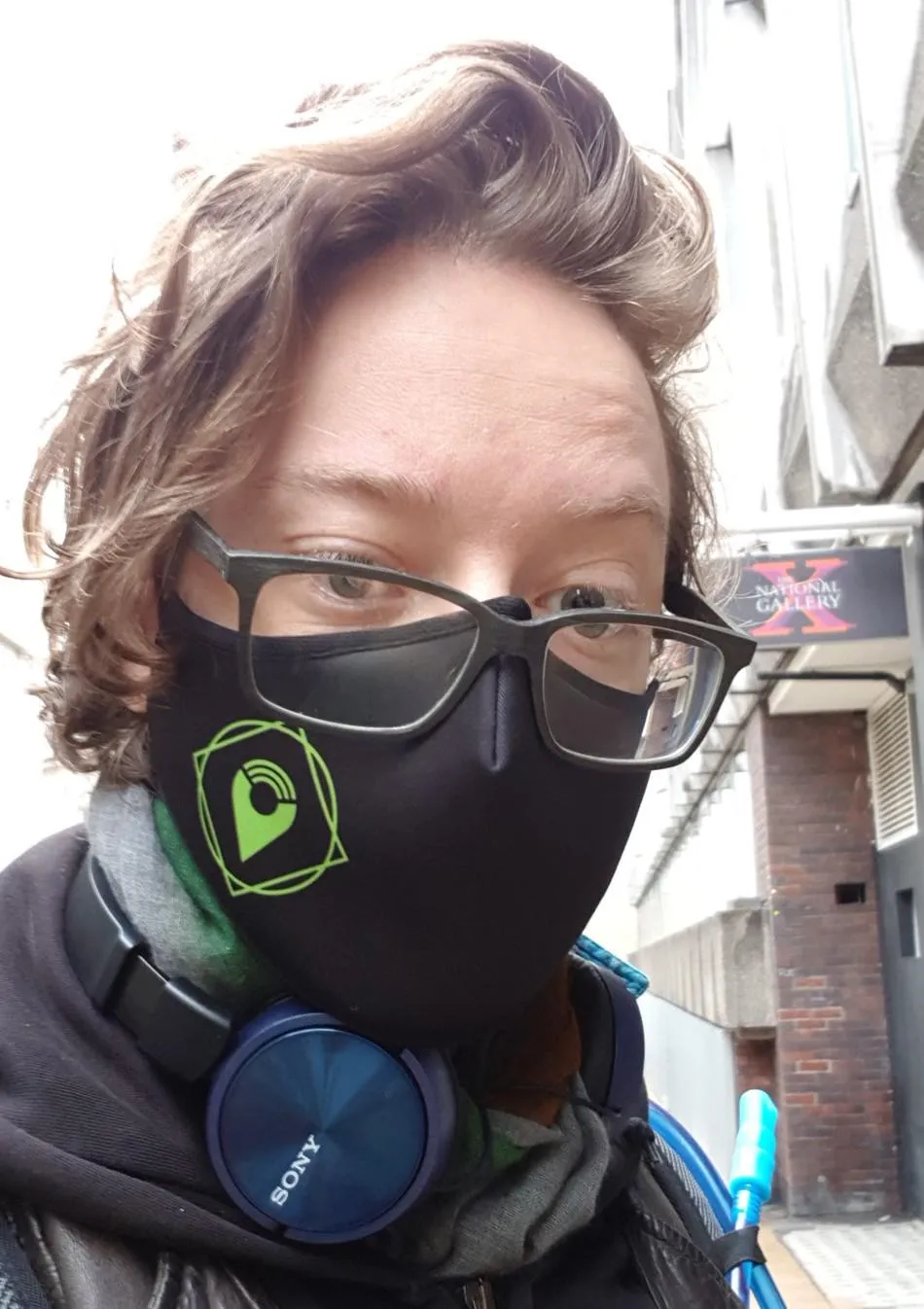 Image shows Robert Morgan wearing a face mask and standing in front of the National Gallery X studio in central London.