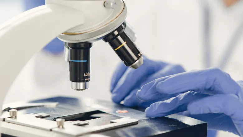 A researcher using a microscope.