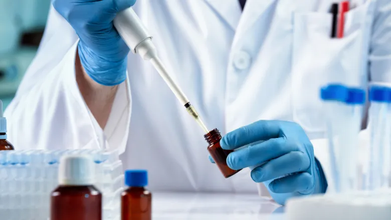 Researcher pipetting in the laboratory.