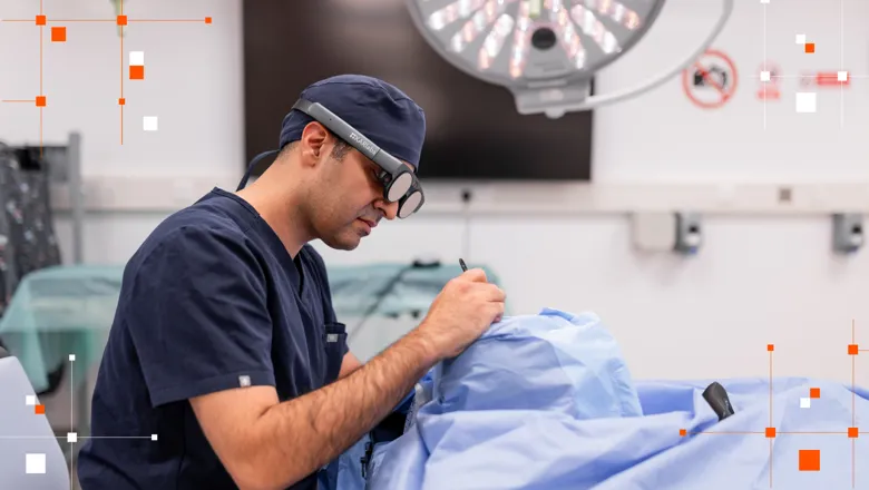 Man performing mock surgery with VR glasses on