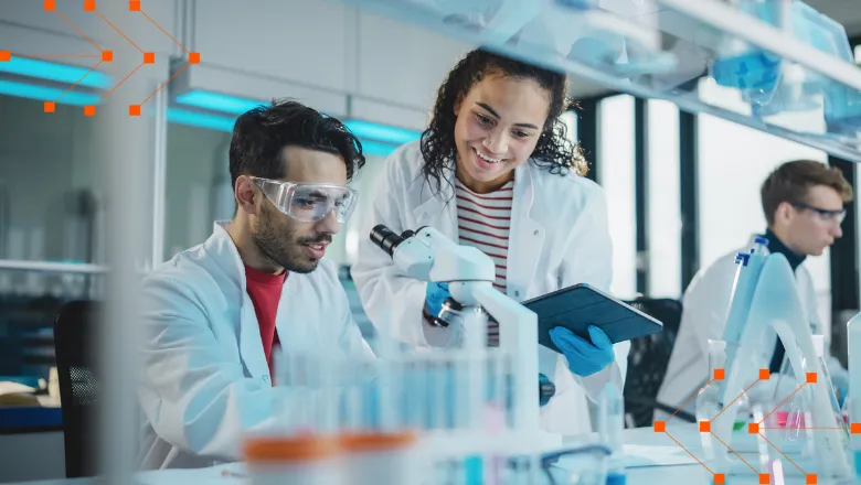 Two students working with a microscope in a clinical lab