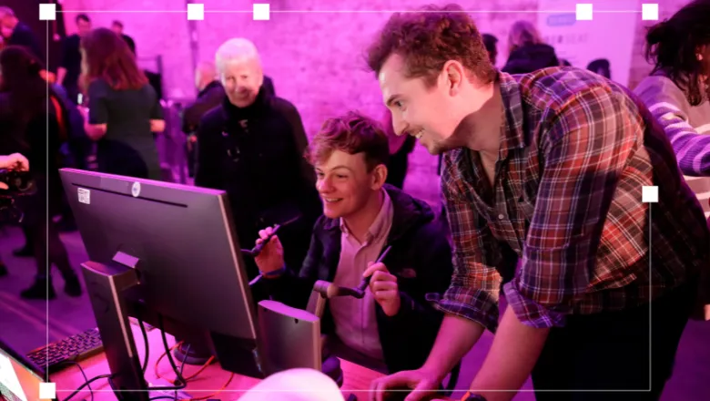 A researcher guiding a young participant through a VR surgical game at the event