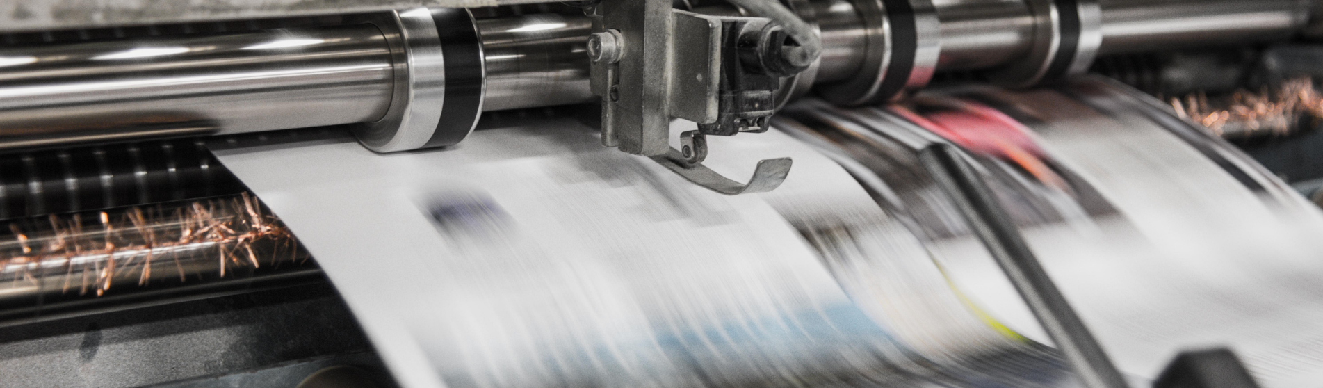 newspapers being made in a machine