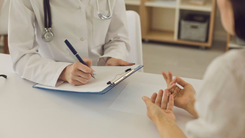 A doctor and patient converse, in a professional healthcare setting.