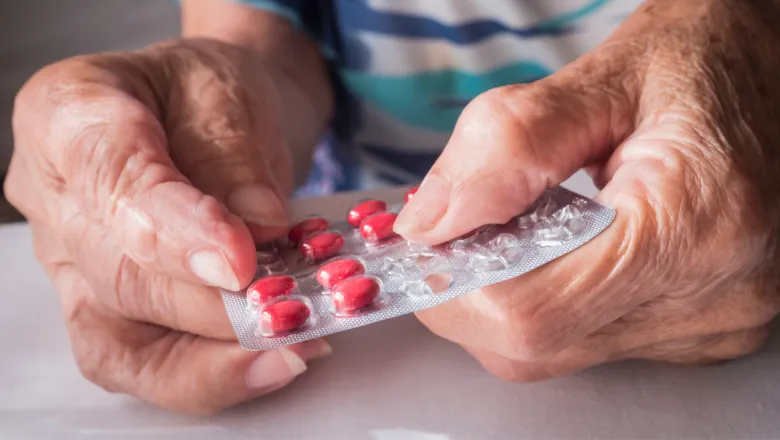 Old person holding medicine