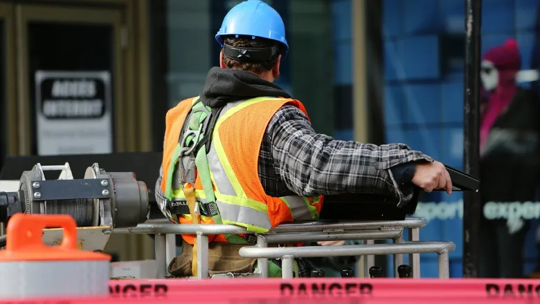 A construction worker in helmet and high visibility vest