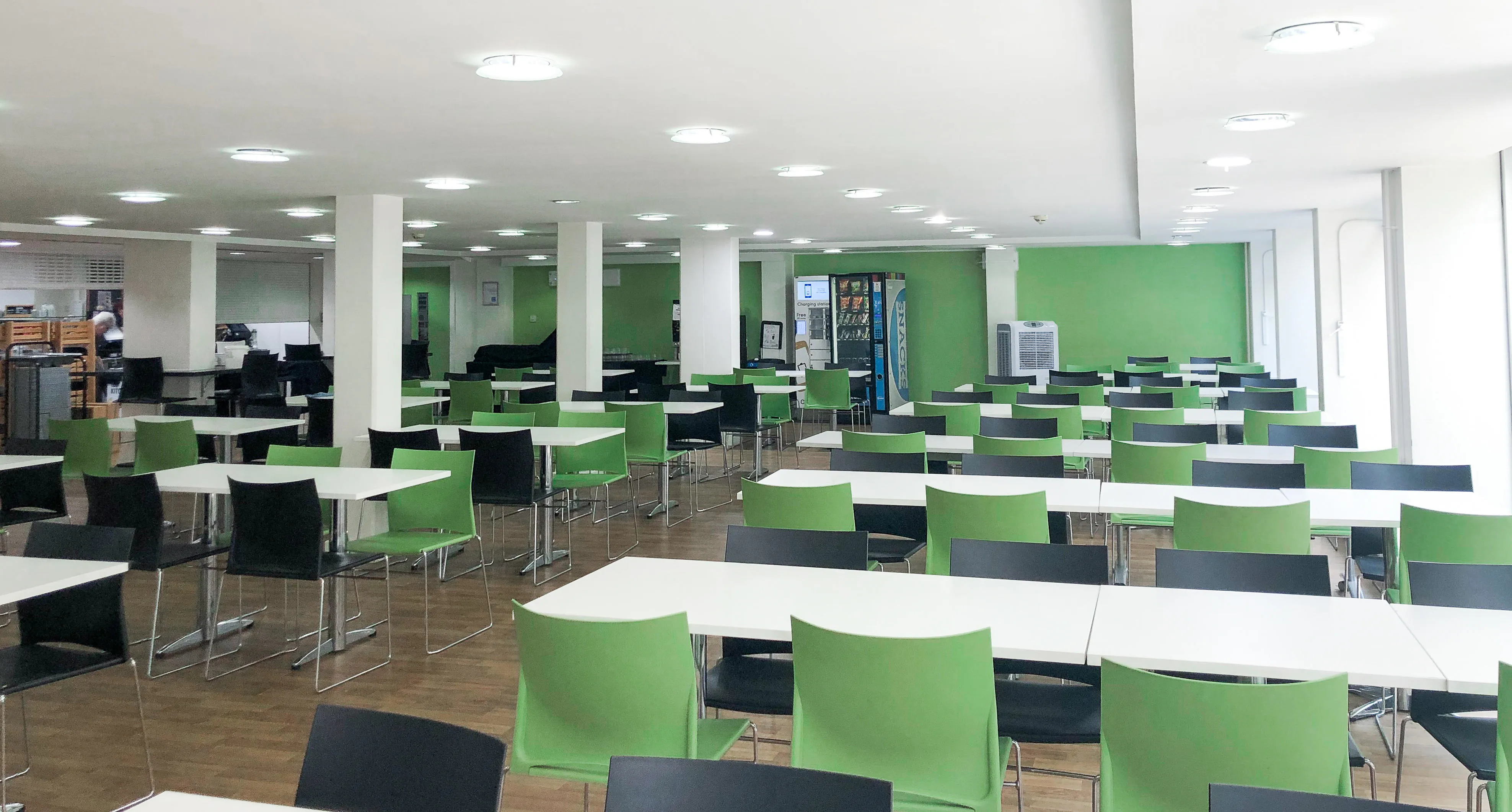 A large empty room, with chairs and dining tables