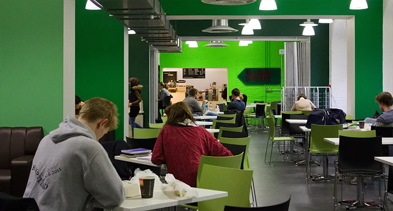 People sitting and studying at tables and chairs