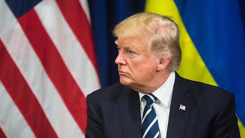 President Donald Trump in front of the US and Ukrainian flags