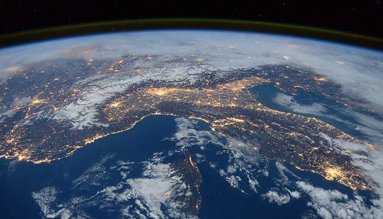 A bird's-eye view of the world from outer space, with glowing lights