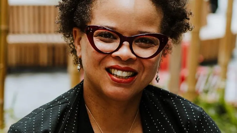 Professor Stephani Hatch smiling, sat outside