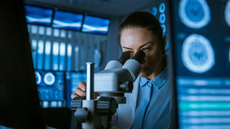 Scientist using a microscope