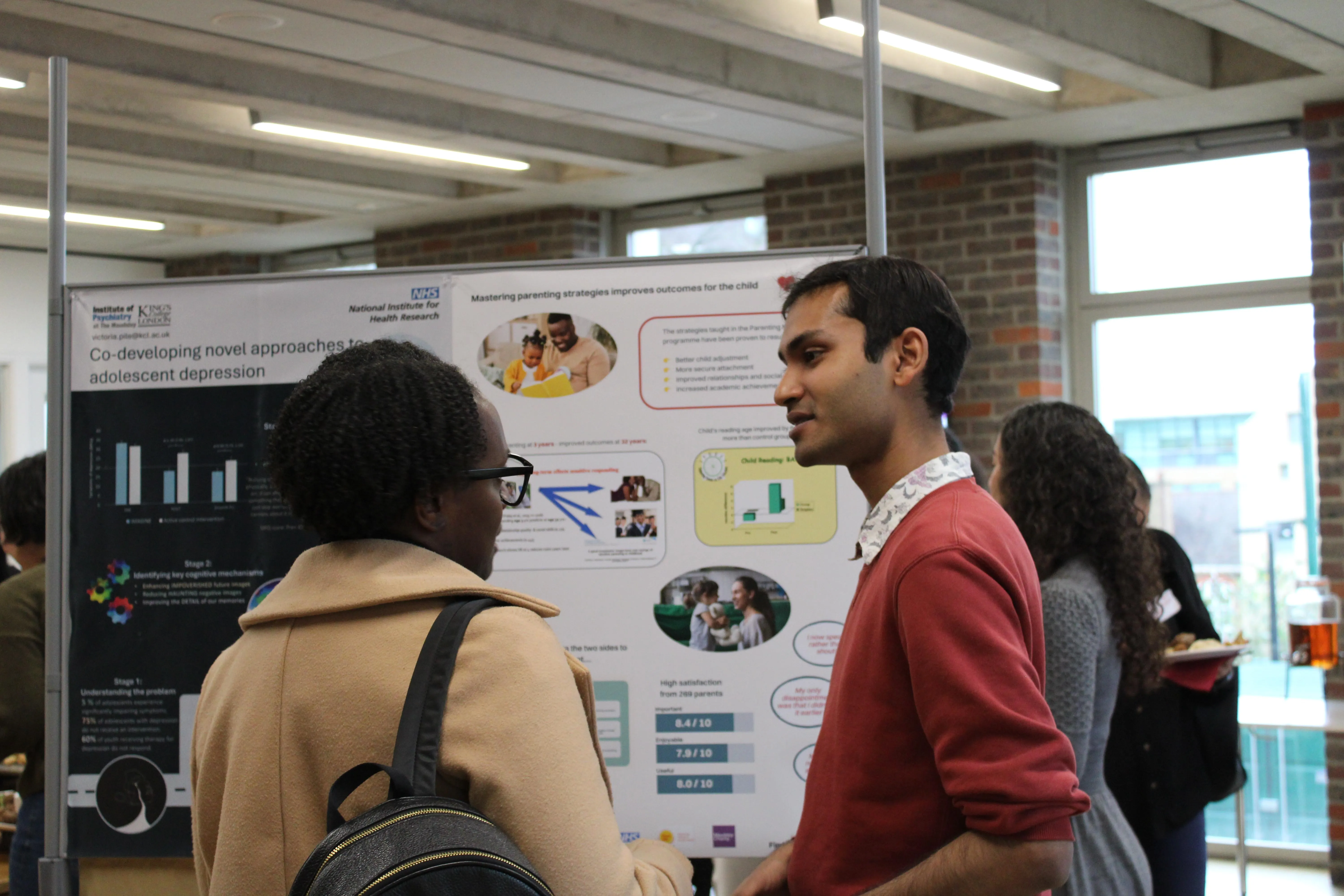 Two attendees looking at posters at the School Mental Health Innovation Network launch event