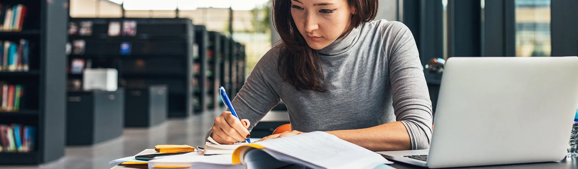 woman-studying-in-library-hero