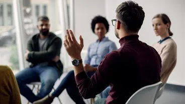 A man talking to a group of people