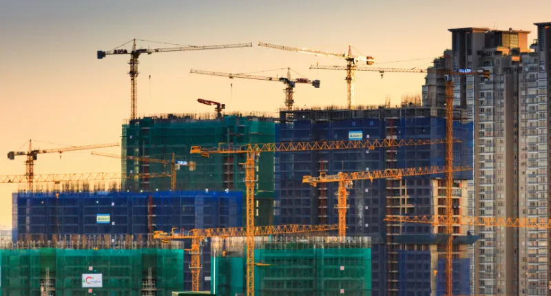 Sky scene of buildings under scaffolding