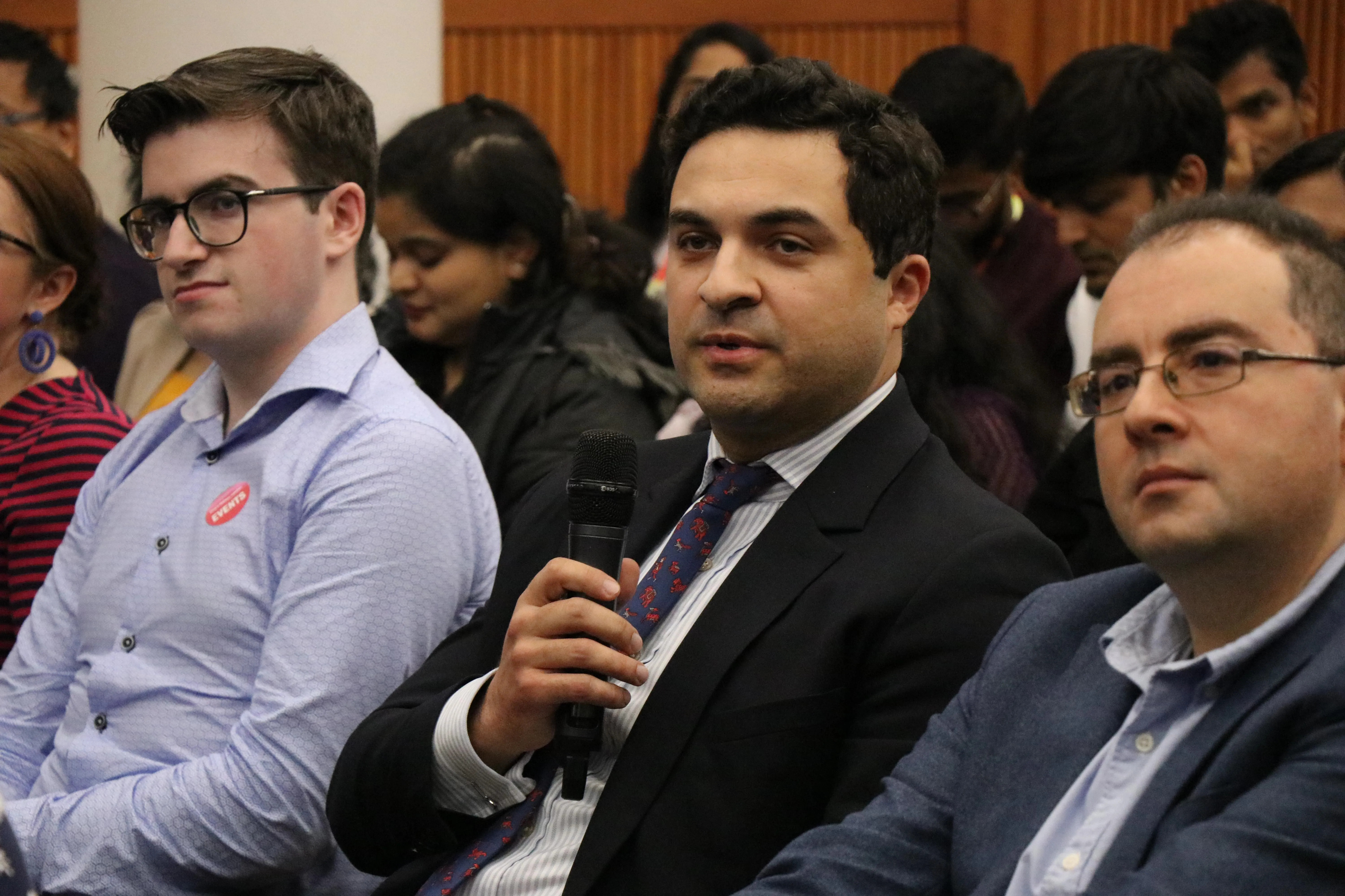 A man asking a question into a microphone