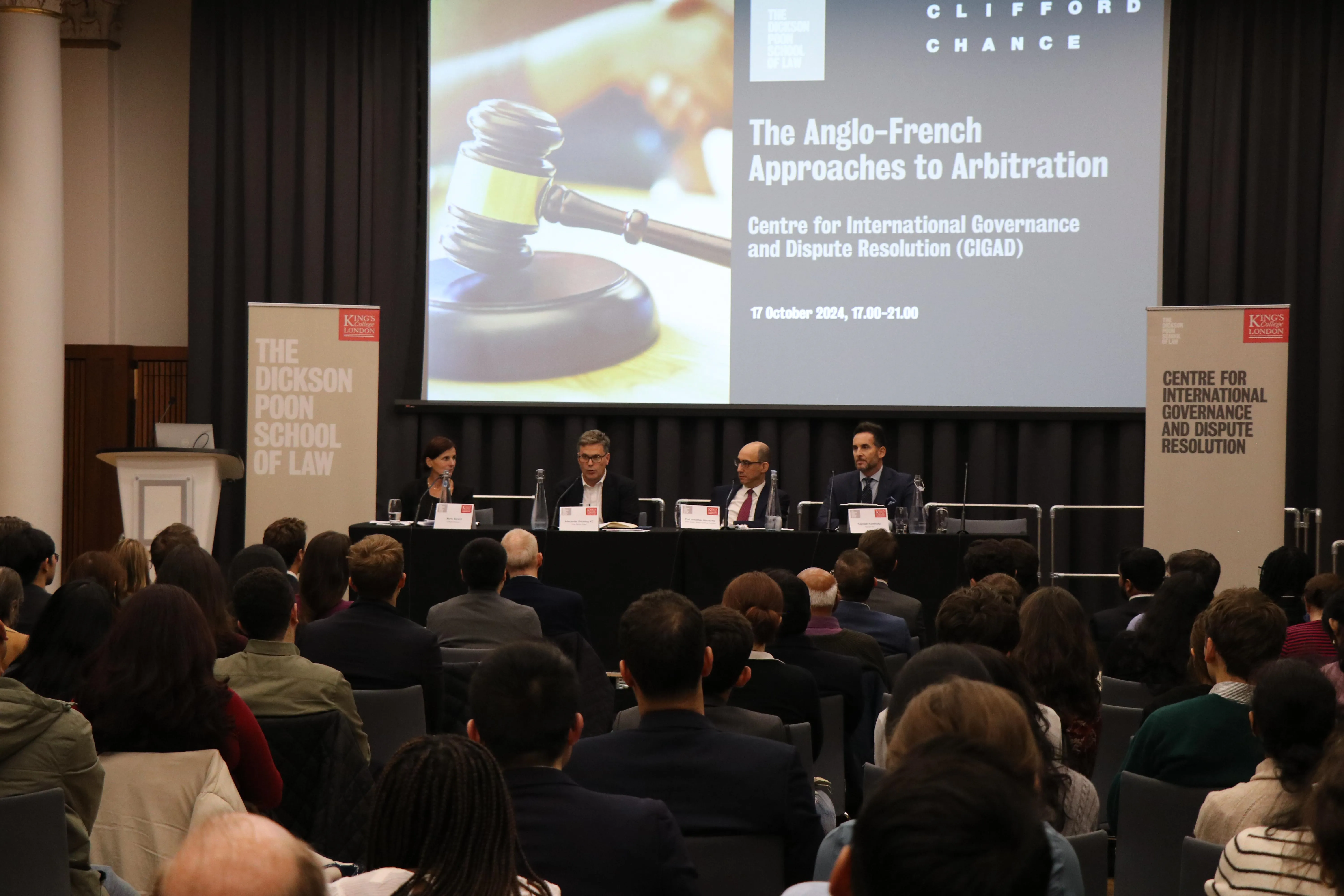 Image of a panel discussion in front of an audience