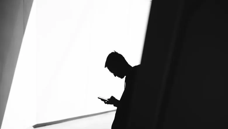 silhouette of a man on his phone