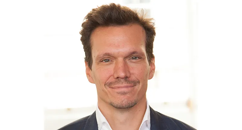 Headshot of Professor Christoph Kletzer in front of a window