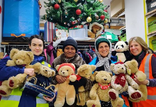 Lewisham Donation Hub volunteers holding teddy bears.