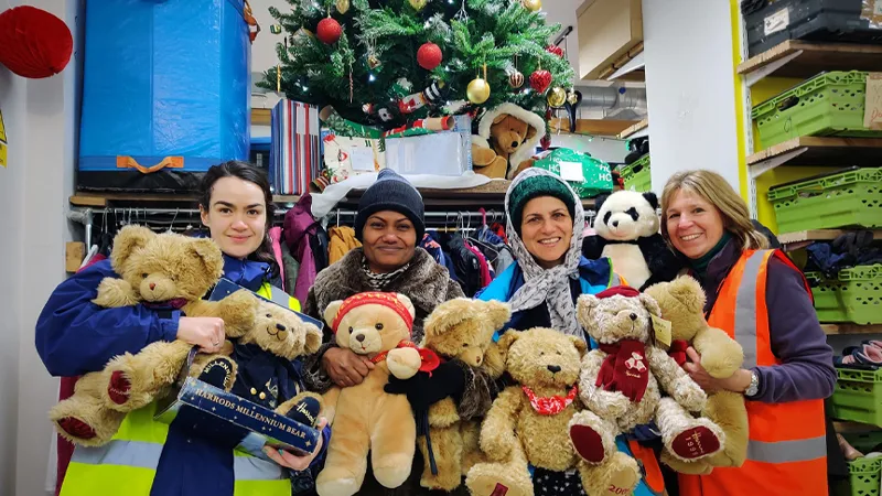 Lewisham Donation Hub volunteers holding teddy bears.